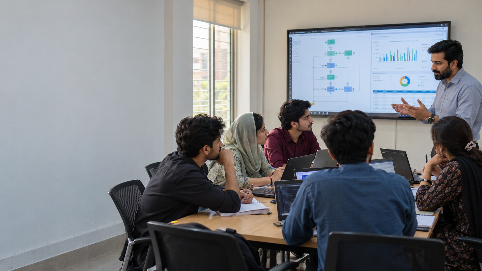 Pakistani BIT students learning automation workflows in a physical classroom